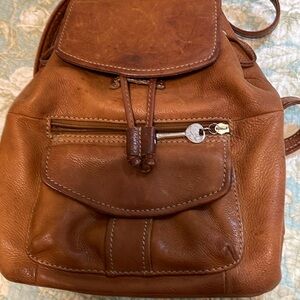 Fossil leather backpack with two pockets inside.  10 By 11 inches tall.